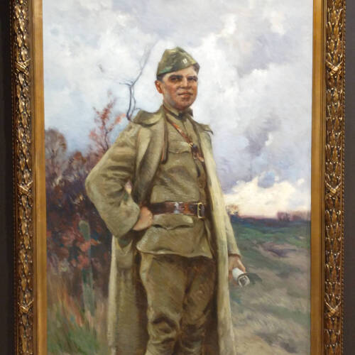 Painting of a soldier in an elaborate gold frame with an eagle.